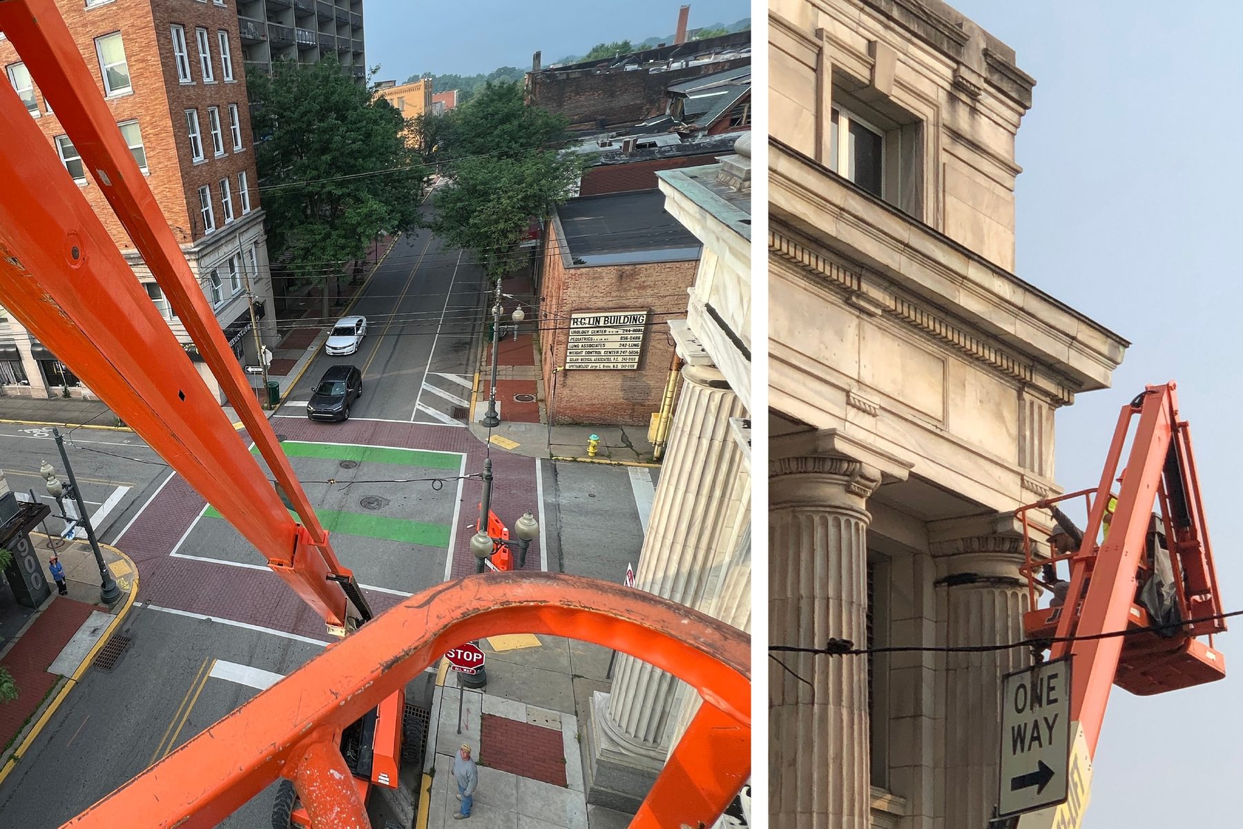The view from a raised boom lift over a street corner, beside a columned stone facade